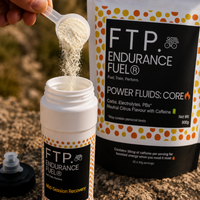 Scooping Power Fluids Core neutral citrus drink mix powder into a bottle before a session