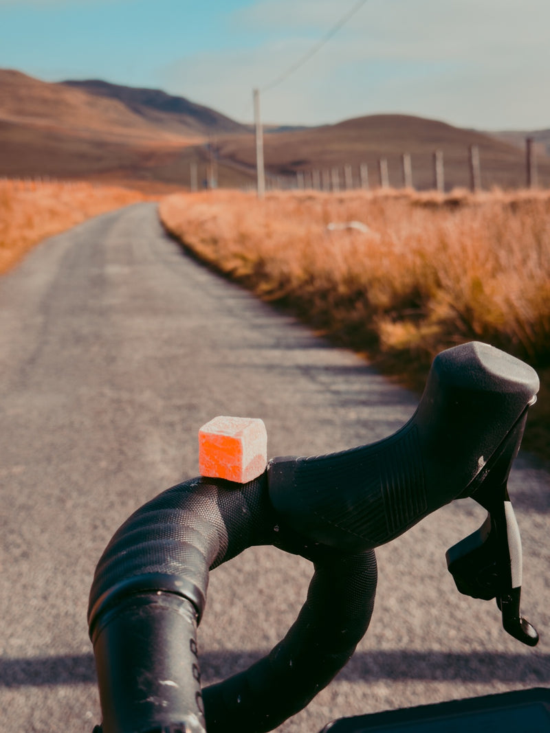 Energy Pastille balanced on drop handlebars on a long ride